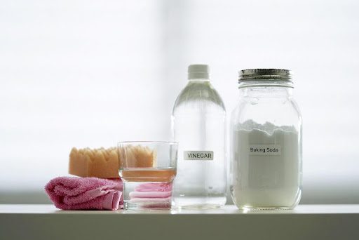 A jar of baking soda and a bottle of vinegar sit on a counter at a home in Caseyville, IL.