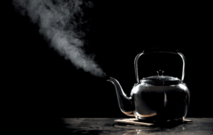 A black tea kettle emitting steam in Caseyville, IL.