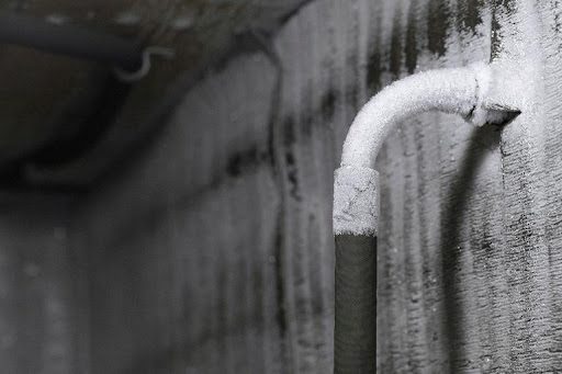 A frozen plumbing pipe in Caseyville, IL that is frozen due to a quick drop in temperature. A pipe that has frozen over on the inside wall of a home.