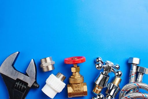 An assortment of plumbing tools and equipment on a blue background in Caseyville, IL.