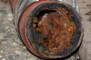 Broken pipe caked with grease and grime in Belleville, Illinois