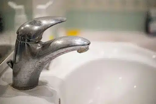Close-up of a faucet with limescale buildup in the home of a Collinsville, IL resident.